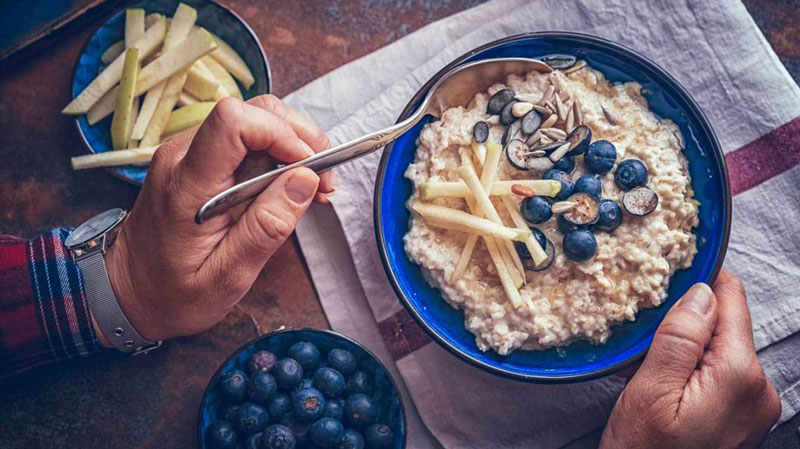 Man eating bowl of oatmeal