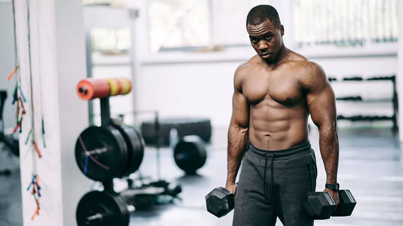 athlete using dumbbells to get jacked