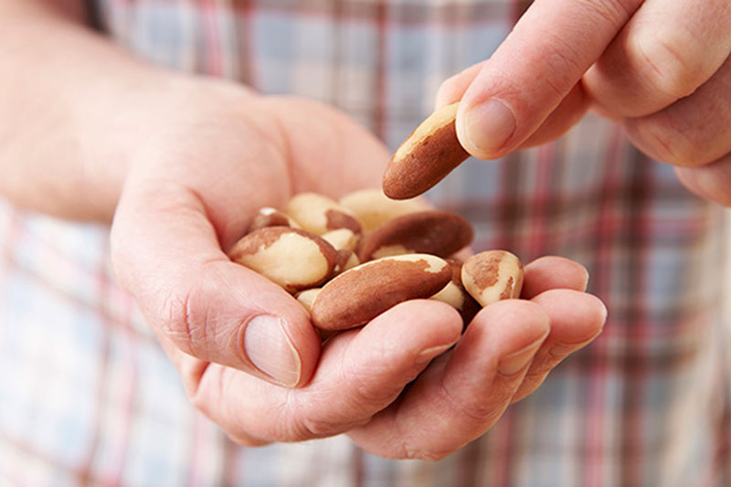 Man holding nuts as keto snack
