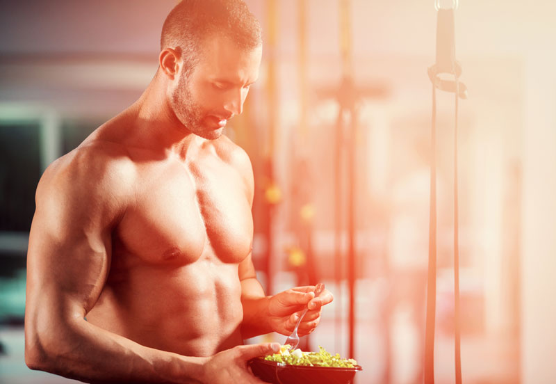 Bodybuilder eating meal prepped food that fits his diet budget
