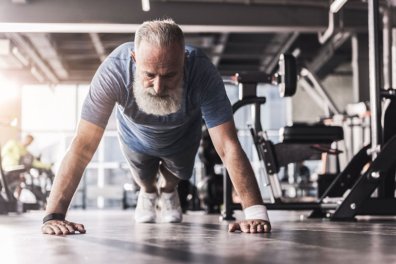 Man performing pushups to prevent muscle loss after 50