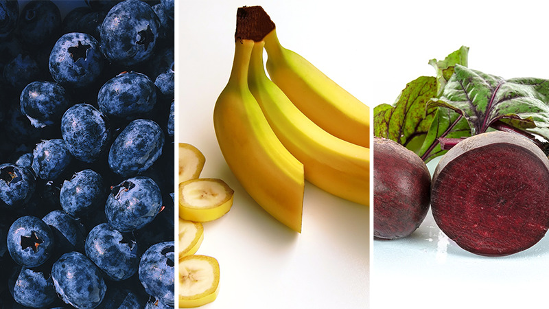 Carb rich foods shown as blueberries, banana, and beetroot