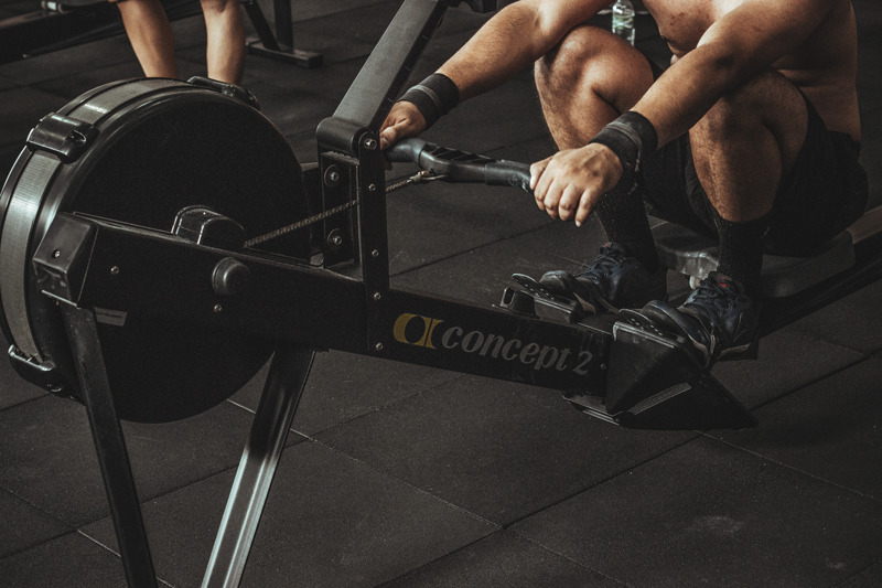 Man performing fasted HIIT cardio on rowing machine