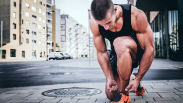 Man lacing up training shoes during fasted cardio for fat loss