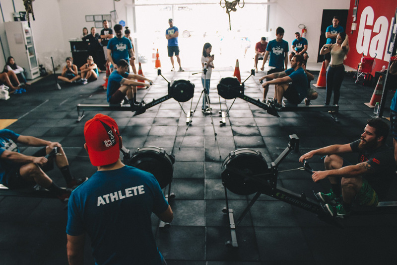CrossFit athletes performing safe amount of cardio on rowing machines