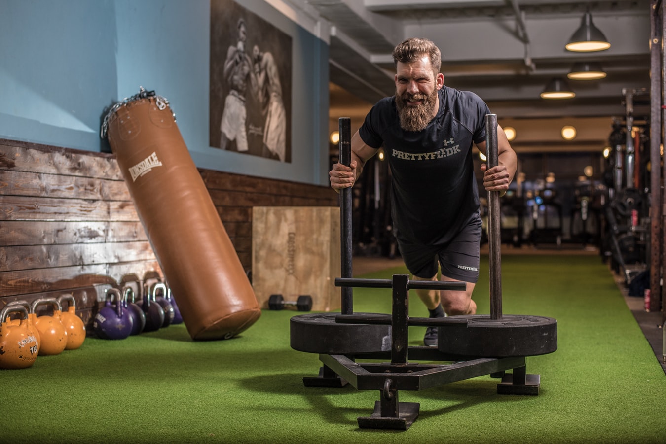 Man pushing prowler as part of strength and conditioning workout